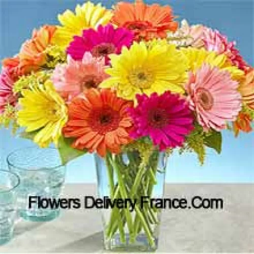 25 Mixed Colored Gerberas With Some Ferns In A Glass Vase