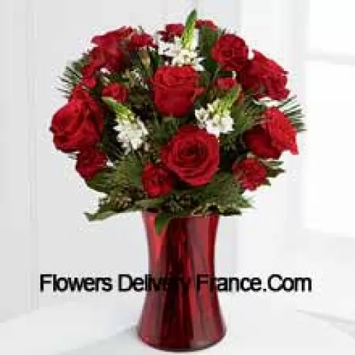 This romantic arrangement bristles with the passion and wonder of the Christmas season. Rich red roses and burgundy mini carnations accented with the snowy white blooms of Stars of Bethlehem, pine branches, and lush greens will easily sweep them off their feet. Arranged in a ruby red clear glass vase, this bouquet conveys your most heartfelt holiday wishes. (Please Note That We Reserve The Right To Substitute Any Product With A Suitable Product Of Equal Value In Case Of Non-Availability Of A Certain Product)