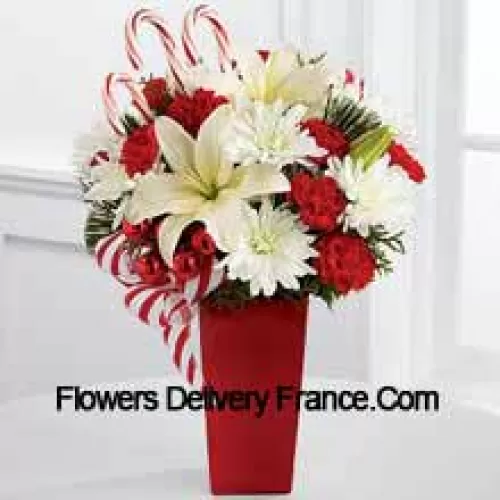 Bursts with the bright cheer and jubilant beauty of this special season. White Asiatic Lilies and chrysanthemums sit amongst red mini carnations, assorted holiday greens, red glass balls, three candy canes and festive ribbon, perfectly arranged in a red ceramic vase to create a lively bouquet of merry wishes for a splendid holiday season! (Please Note That We Reserve The Right To Substitute Any Product With A Suitable Product Of Equal Value In Case Of Non-Availability Of A Certain Product)