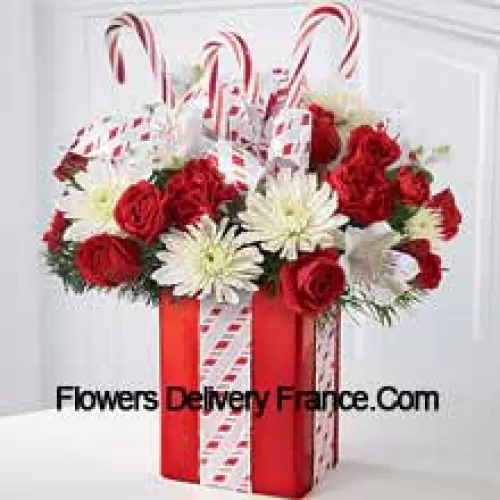 This Bouquet will dazzle them with its whimsical joy and spirited beauty! A gorgeous arrangement of white mums, red carnations and spray roses sit amongst holiday greens in a shiny red vase adorned with candy canes and wrapped to perfection with a beautiful bow, making it look like the finest holiday gift. (Please Note That We Reserve The Right To Substitute Any Product With A Suitable Product Of Equal Value In Case Of Non-Availability Of A Certain Product)